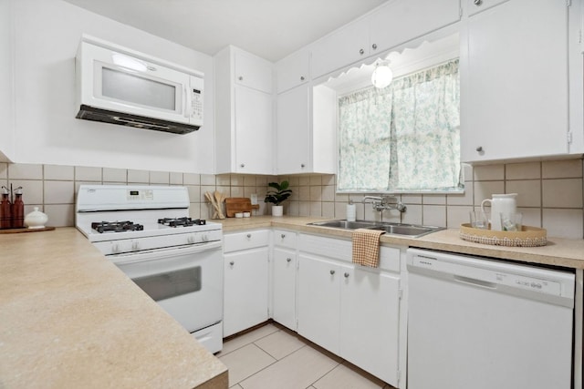 1409 Briarcliff Blvd, Austin, TX 78723 - kitchen with white appliances, light countertops, decorative backsplash, and white cabinetry