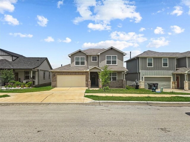 view of front of house featuring concrete driveway, brick siding, board and batten siding, and an attached garage