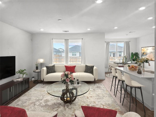 living area featuring light wood-style floors, recessed lighting, and baseboards