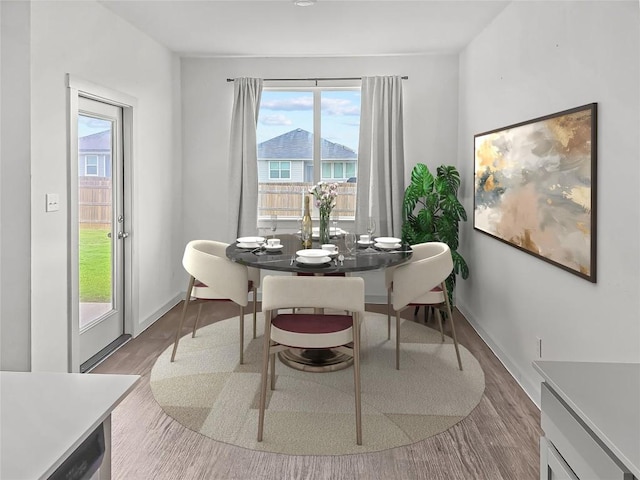 dining room with wood finished floors and baseboards