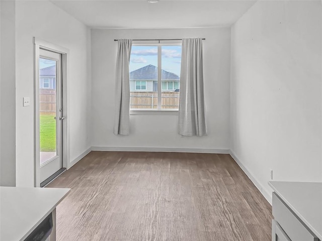 empty room with wood finished floors and baseboards