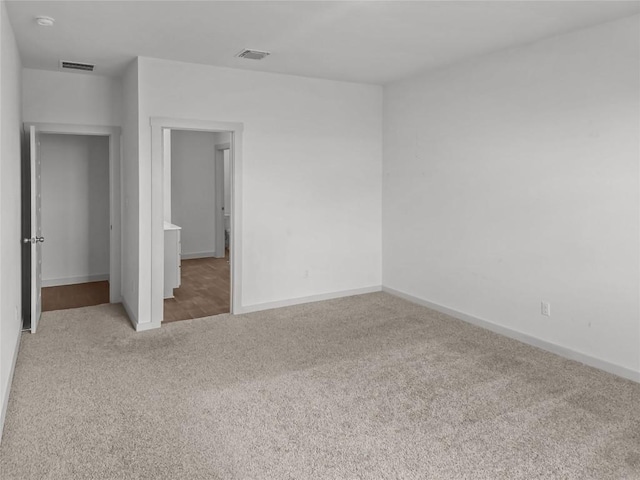 unfurnished bedroom with carpet flooring and baseboards