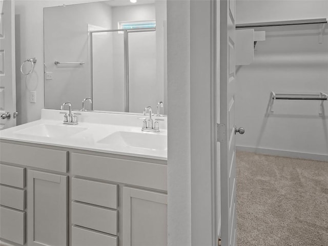 full bathroom with a stall shower and double vanity