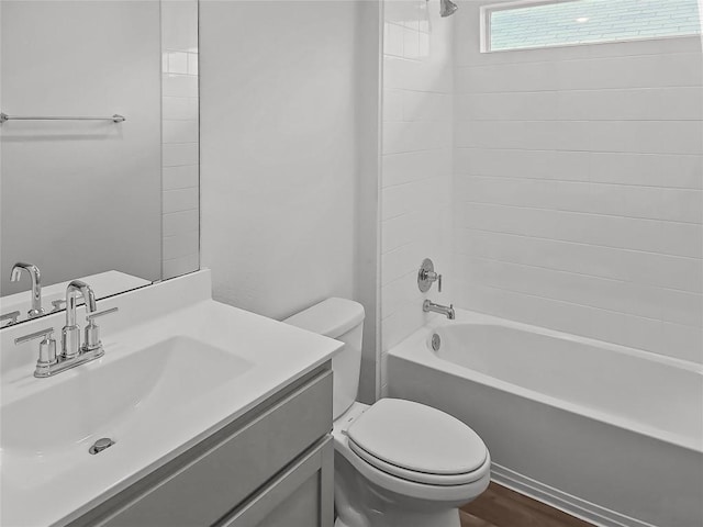 bathroom with toilet, shower / bathtub combination, vanity, and wood finished floors