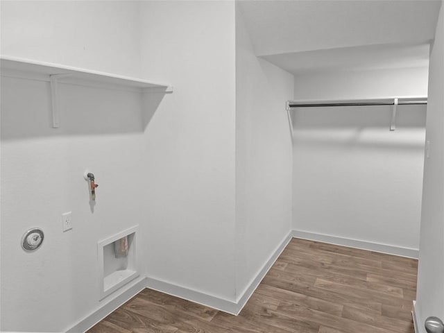 laundry area featuring gas dryer hookup, dark wood finished floors, and baseboards