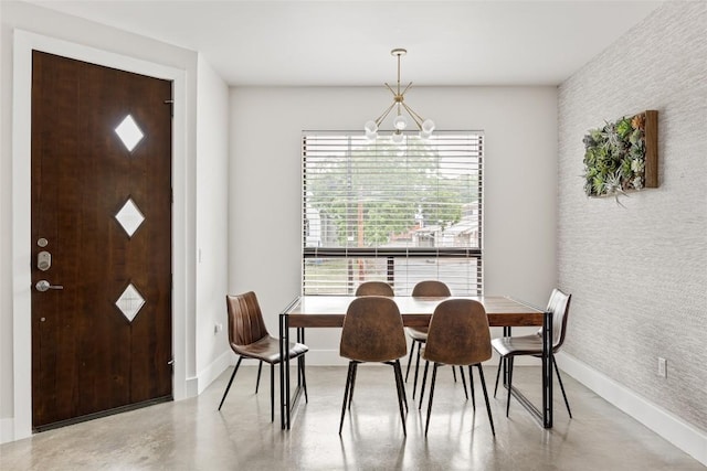 1103 12th St E, Austin, TX 78702 - dining space featuring baseboards, a chandelier, and finished concrete flooring