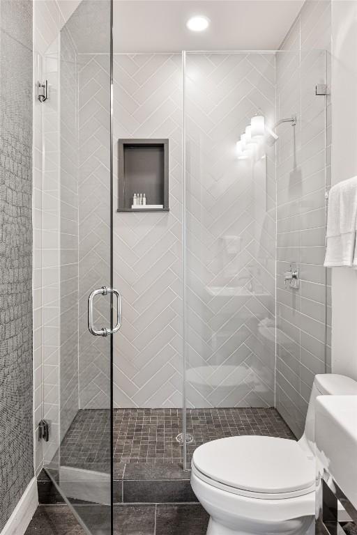 1103 12th St E, Austin, TX 78702 - bathroom with toilet, a shower stall, and recessed lighting