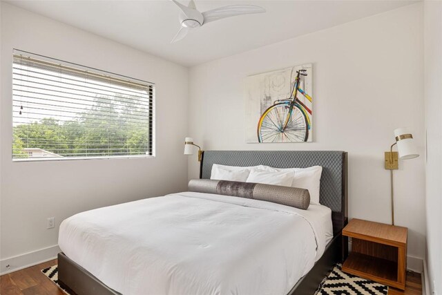 1103 12th St E, Austin, TX 78702 - bedroom with wood finished floors, baseboards, and ceiling fan