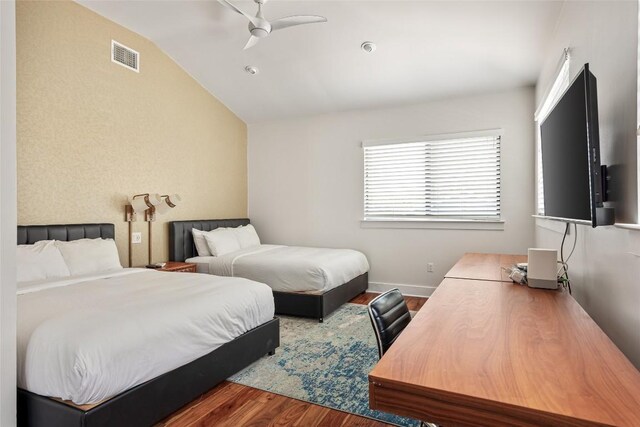1103 12th St E, Austin, TX 78702 - bedroom with dark wood finished floors, lofted ceiling, and a ceiling fan
