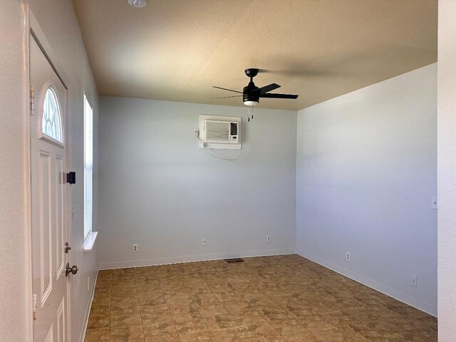251 Zimmerman Ave A-B-C-D, Unit A-B-C-D, Bastrop, TX 78602 - spare room featuring a wall mounted air conditioner, ceiling fan, and baseboards