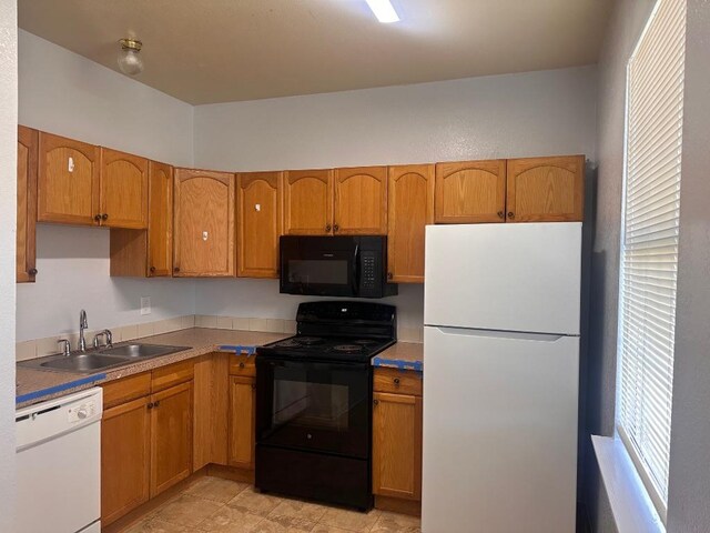 251 Zimmerman Ave A-B-C-D, Unit A-B-C-D, Bastrop, TX 78602 - kitchen with black appliances, a sink, and brown cabinets