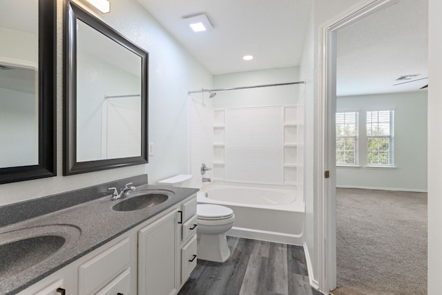 2306 Mccombs St, Georgetown, TX 78626 - bathroom featuring toilet, double vanity, shower / bath combination, and wood finished floors