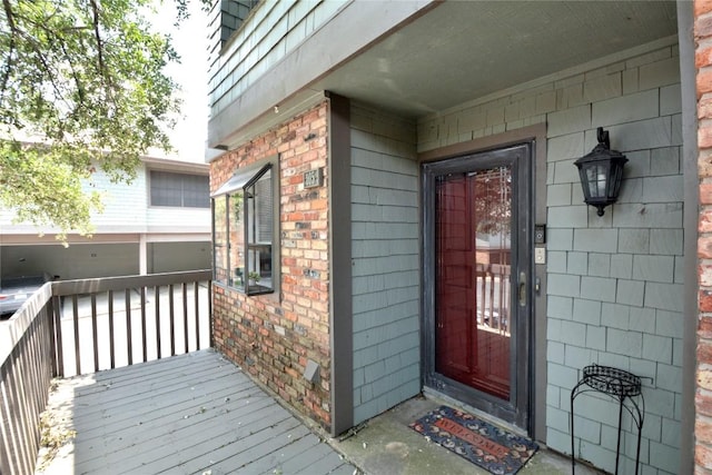 7122 Woodhollow Dr Unit 105, Austin, TX 78731 - entrance to property with brick siding and a wooden deck