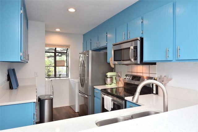 7122 Woodhollow Dr Unit 105, Austin, TX 78731 - kitchen featuring stainless steel appliances, blue cabinets, light countertops, recessed lighting, and dark wood finished floors