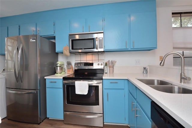 7122 Woodhollow Dr Unit 105, Austin, TX 78731 - kitchen with stainless steel appliances, blue cabinetry, light countertops, and wood finished floors