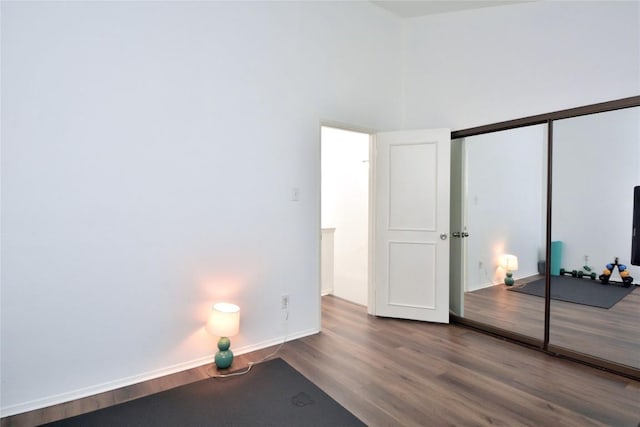 7122 Woodhollow Dr Unit 105, Austin, TX 78731 - unfurnished bedroom featuring wood finished floors and a closet