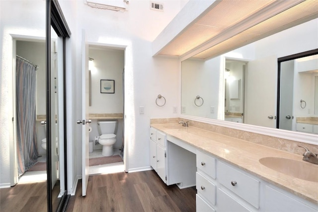 7122 Woodhollow Dr Unit 105, Austin, TX 78731 - bathroom featuring wood finished floors and double vanity