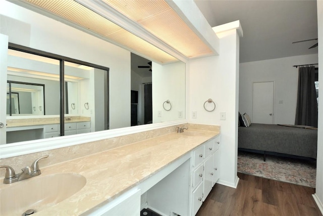 7122 Woodhollow Dr Unit 105, Austin, TX 78731 - bathroom featuring ensuite bath, double vanity, and wood finished floors