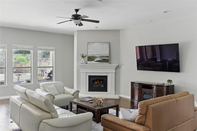 4121 Vinalopo Dr, Austin, TX 78738 - living room featuring wood finished floors, a ceiling fan, a glass covered fireplace, and recessed lighting