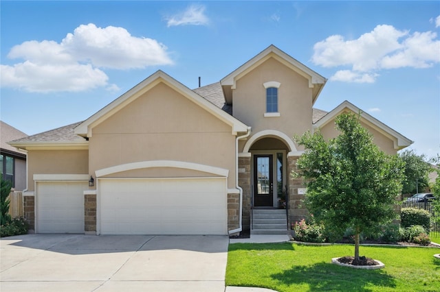 4121 Vinalopo Dr, Austin, TX 78738 - view of front of home with stone siding, stucco siding, an attached garage, and a front lawn
