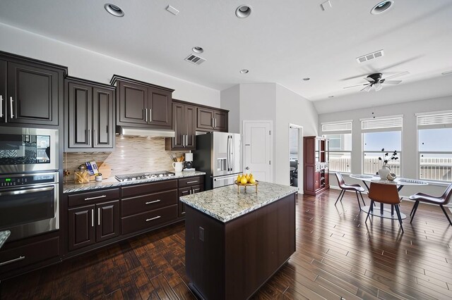 4121 Vinalopo Dr, Austin, TX 78738 - kitchen featuring stainless steel appliances, a center island, backsplash, under cabinet range hood, and a ceiling fan