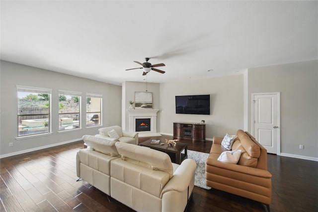 4121 Vinalopo Dr, Austin, TX 78738 - living room featuring ceiling fan, dark wood finished floors, and a warm lit fireplace