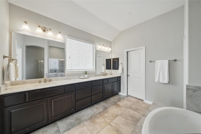 4121 Vinalopo Dr, Austin, TX 78738 - bathroom featuring lofted ceiling, double vanity, a freestanding tub, tile patterned flooring, and a shower
