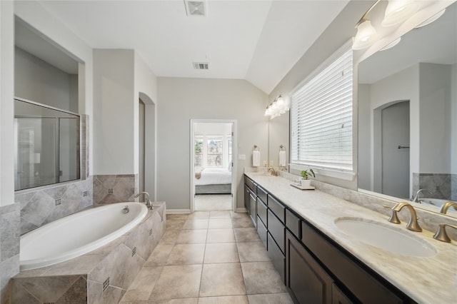 4121 Vinalopo Dr, Austin, TX 78738 - ensuite bathroom with a bath, double vanity, vaulted ceiling, and tile patterned floors