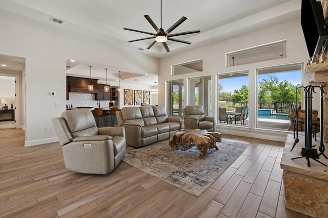 10900 Ranch Road 1323, Johnson City, TX 78636 - living room with a ceiling fan, a high ceiling, light wood finished floors, baseboards, and recessed lighting