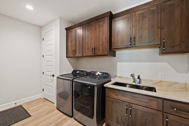 10900 Ranch Road 1323, Johnson City, TX 78636 - clothes washing area featuring washer and clothes dryer, cabinet space, light wood-style floors, baseboards, and recessed lighting
