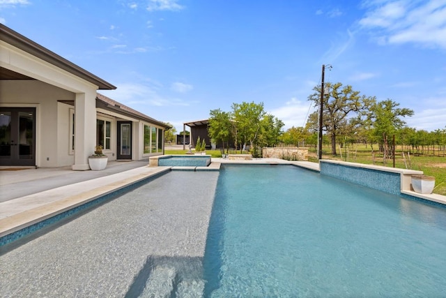 10900 Ranch Road 1323, Johnson City, TX 78636 - outdoor pool featuring a patio, an in-ground hot tub, and french doors