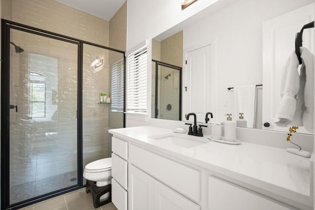 1244 Calendula Trl, Georgetown, TX 78628 - bathroom featuring vanity, a stall shower, toilet, and tile patterned floors