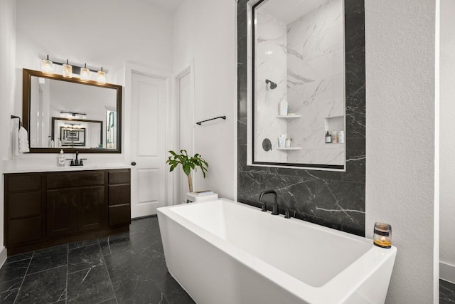 1244 Calendula Trl, Georgetown, TX 78628 - full bath with a soaking tub, marble finish flooring, and vanity