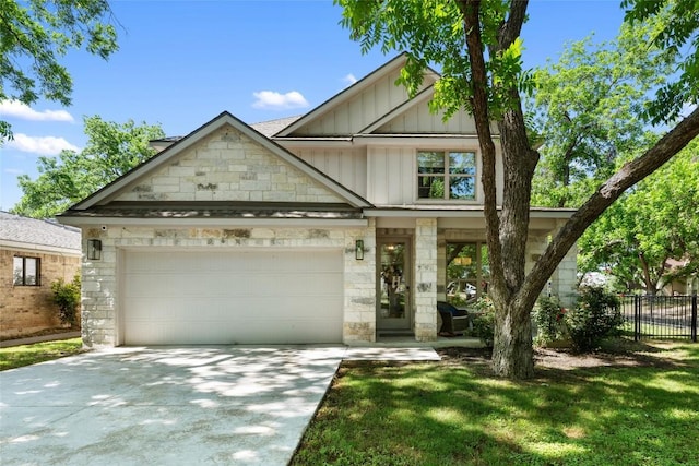 417 Wichita St, Meadowlakes, TX 78654 - view of front facade with board and batten siding, concrete driveway, fence, stone siding, and a garage