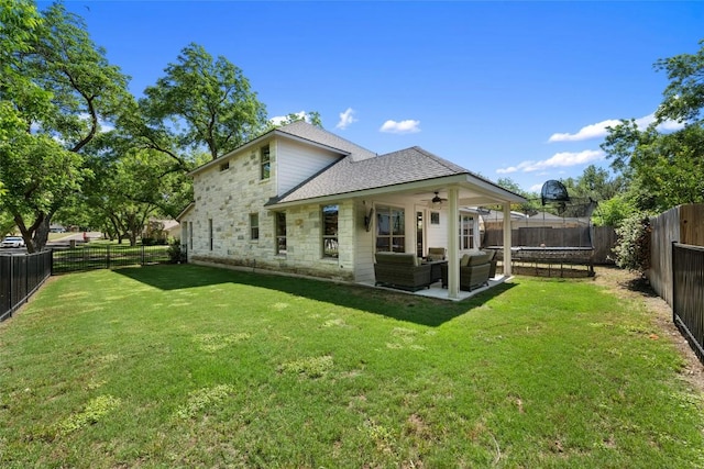 417 Wichita St, Meadowlakes, TX 78654 - rear view of property with a trampoline, ceiling fan, an outdoor living space, a shingled roof, and stone siding