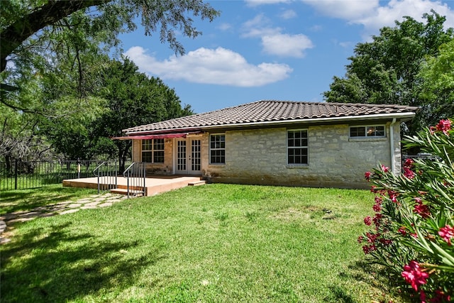 104 Springfield, Horseshoe Bay, TX 78657 - rear view of house featuring french doors, stone siding, a tile roof, and a patio area