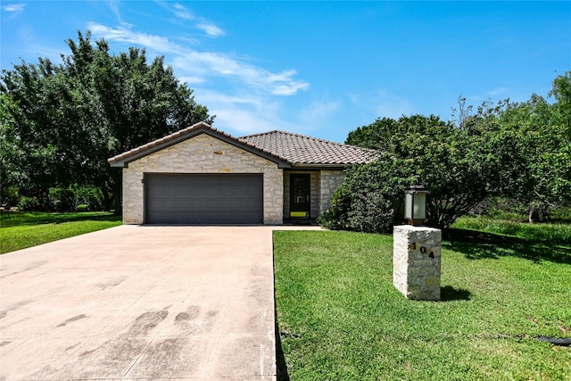104 Springfield, Horseshoe Bay, TX 78657 - ranch-style house featuring concrete driveway, a tiled roof, a front lawn, and a garage