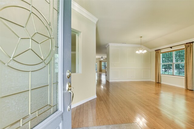 104 Springfield, Horseshoe Bay, TX 78657 - entryway featuring a chandelier, ornamental molding, light wood-style floors, and baseboards