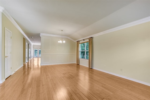 104 Springfield, Horseshoe Bay, TX 78657 - unfurnished room featuring a chandelier, light wood finished floors, crown molding, baseboards, and vaulted ceiling