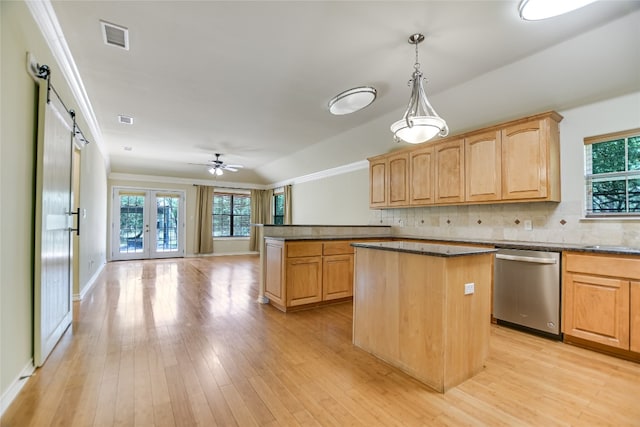 104 Springfield, Horseshoe Bay, TX 78657 - kitchen with stainless steel dishwasher, a center island, healthy amount of natural light, backsplash, and crown molding
