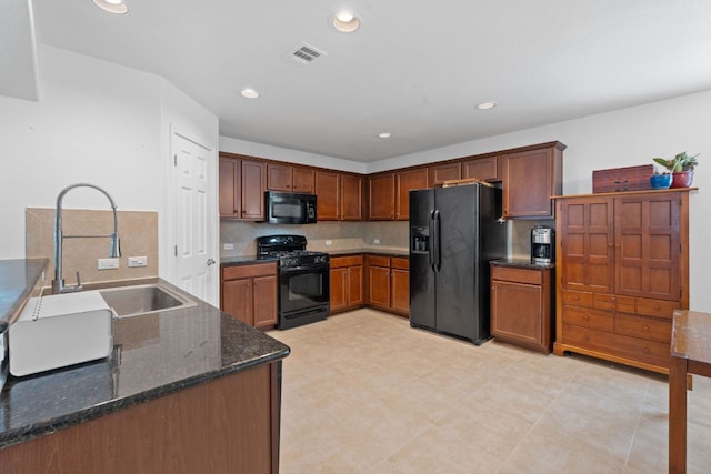 11505 Buster Crabbe Dr, Austin, TX 78748 - kitchen featuring black appliances, a sink, recessed lighting, dark stone countertops, and decorative backsplash