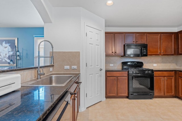 kitchen with black appliances, a sink, dark stone counters, decorative backsplash, and light tile patterned floors