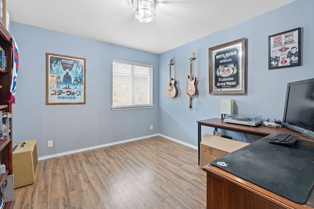 office with wood finished floors, baseboards, and a ceiling fan