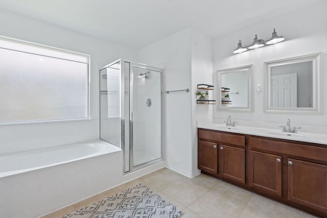 bathroom featuring tile patterned flooring, a stall shower, a bath, and double vanity