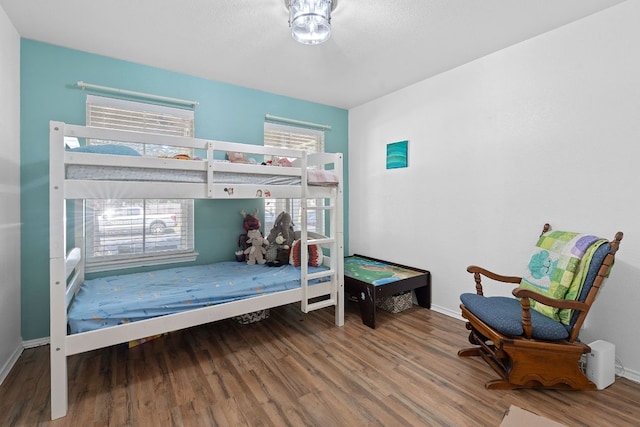 bedroom with wood finished floors and baseboards