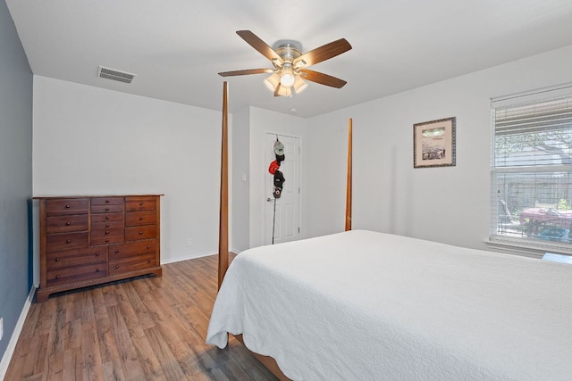 bedroom with wood finished floors, baseboards, and a ceiling fan