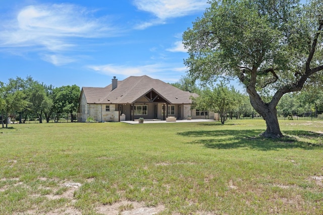 106 Gabriel Woods Dr, Georgetown, TX 78633 - rear view of house featuring a chimney, a yard, and a patio area