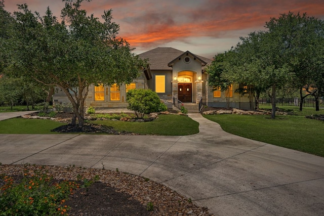 106 Gabriel Woods Dr, Georgetown, TX 78633 - view of front of home featuring stucco siding, a lawn, and stone siding