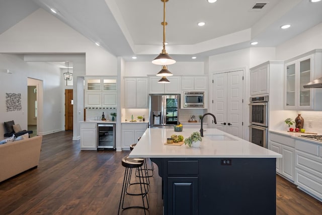 106 Gabriel Woods Dr, Georgetown, TX 78633 - kitchen with recessed lighting, white cabinets, appliances with stainless steel finishes, tasteful backsplash, and a kitchen breakfast bar