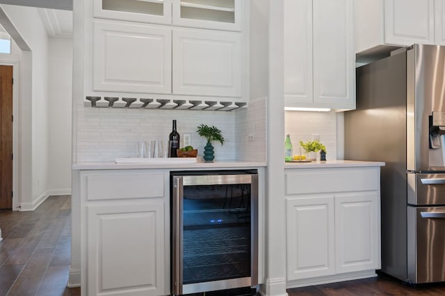 106 Gabriel Woods Dr, Georgetown, TX 78633 - indoor dry bar with wine cooler, stainless steel refrigerator with ice dispenser, dark wood-type flooring, and backsplash